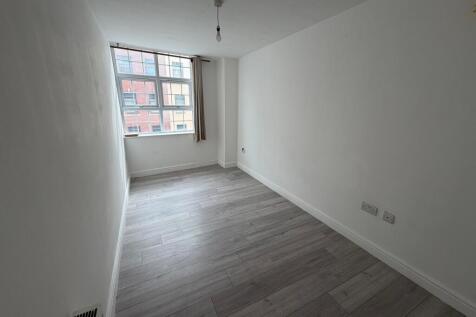 Bright and airy bedroom featuring a large windo...