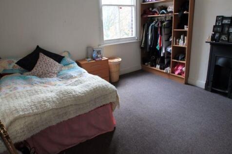 A cozy bedroom featuring a comfortable bed with...