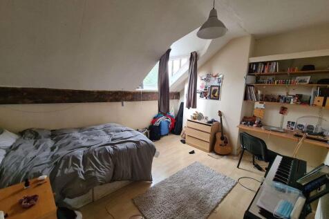 A cozy bedroom featuring a comfortable double b...