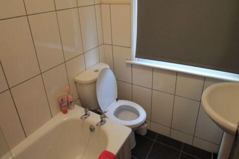 A functional bathroom featuring a standard toil...