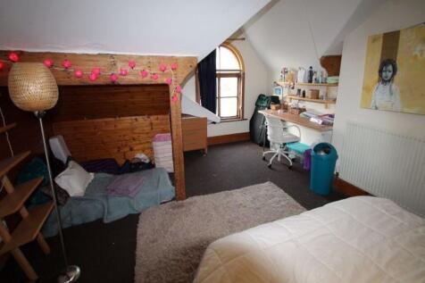 A cozy bedroom with a single bed, a wooden bunk...