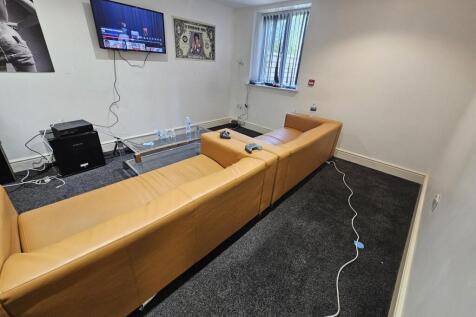 A contemporary living room featuring a large ta...