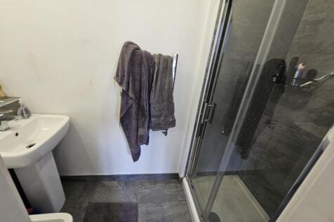 A clean and well-maintained bathroom with a sho...