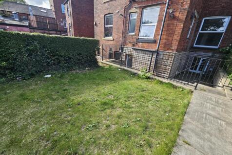 An inviting outdoor garden area featuring well-...