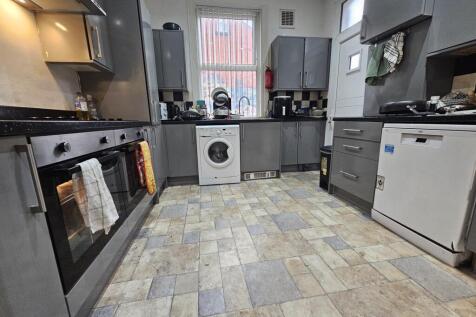 A spacious and well-maintained kitchen with mod...