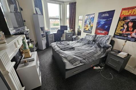 A well-lit, spacious living room with modern fu...