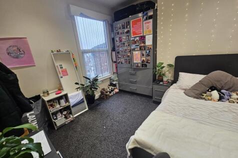 Bright and cozy bedroom with a comfortable bed,...