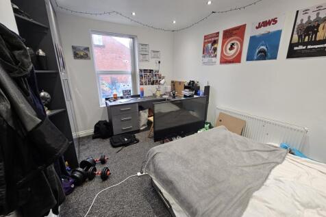 A cozy and well-maintained bedroom featuring a ...