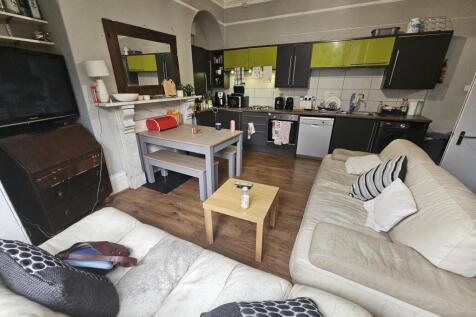 A bright and welcoming living room featuring co...