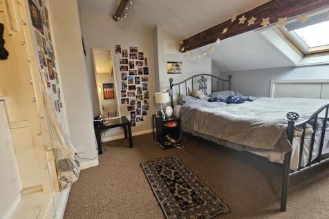 A spacious and well-lit master bedroom featurin...