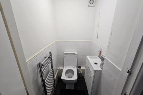 A well-maintained bathroom with a toilet, small...