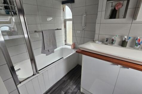 A clean and modern bathroom featuring a large b...