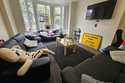 Bright and spacious living room featuring comfo...