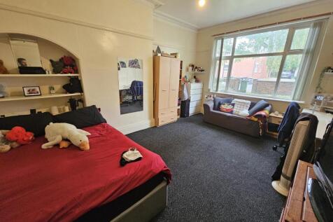 A comfortable double bedroom featuring a spacio...