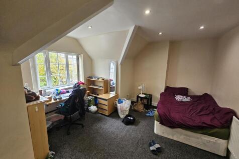 A comfortable, well-lit living room with large ...