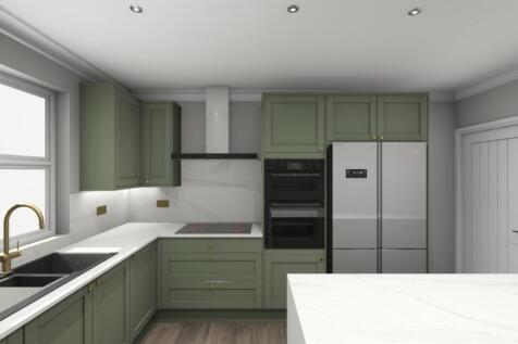 A modern, bright kitchen with stylish green cab...
