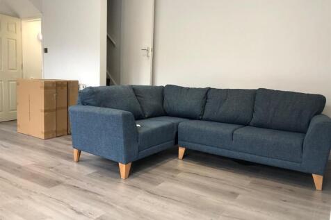 A spacious and modern living room featuring a l...