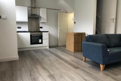 A modern, well-maintained living room with ampl...