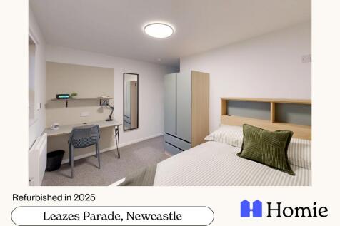 A bright, modern bedroom featuring a neatly mad...