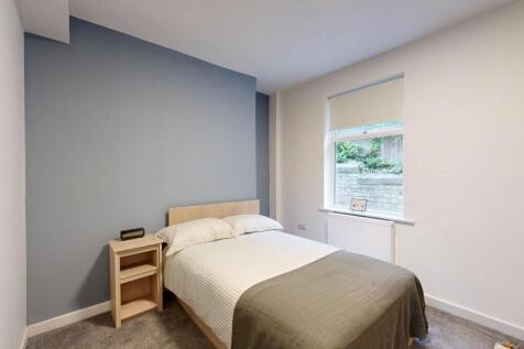A bright and well-maintained bedroom featuring ...
