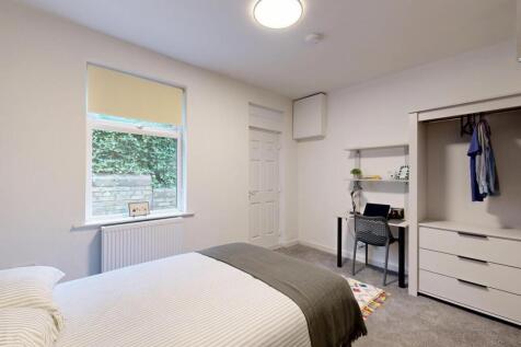 Bright and airy bedroom featuring a comfortable...