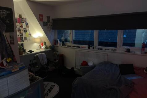 Cozy bedroom with a large window seat and study...