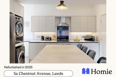 Modern, bright kitchen with ample workspace and...