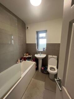 Contemporary bathroom with a bathtub and shower...