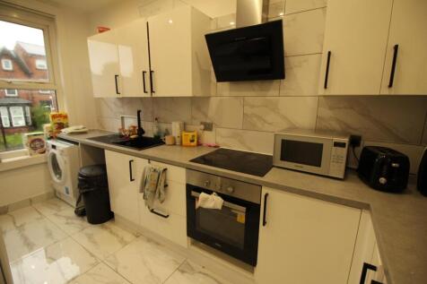 Bright modern kitchen with white gloss cabinets...