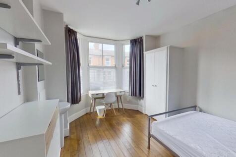 Bright and airy bedroom featuring a comfortable...