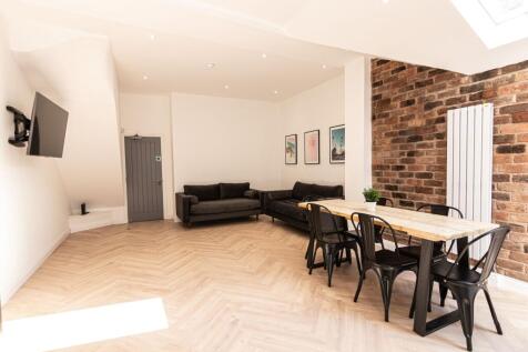 Modern and spacious living room featuring a com...