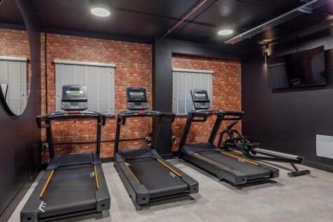 A well-maintained gym area equipped with treadm...