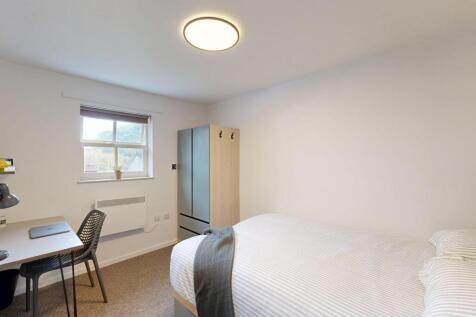 Bright, neatly presented bedroom with a comfort...