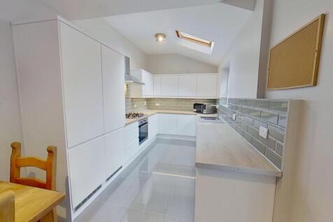 Modern, bright kitchen with sleek white cabinet...