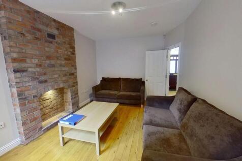 A spacious, well-lit contemporary living room f...