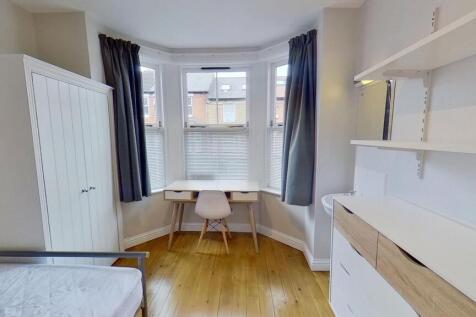 Bright, well-maintained bedroom featuring a lar...