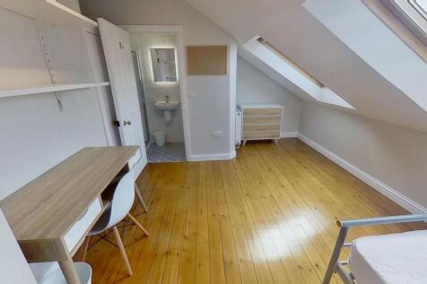 Bright and clean bedroom featuring wooden floor...