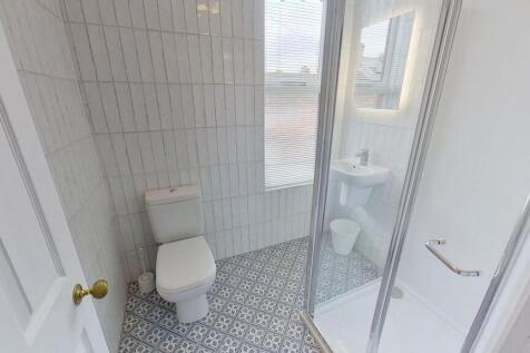 Bright and clean bathroom featuring a spacious ...