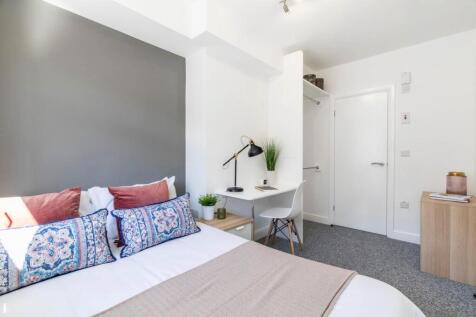 A bright and modern master bedroom featuring a ...