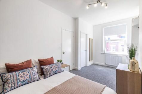 Bright and inviting bedroom featuring a comfort...