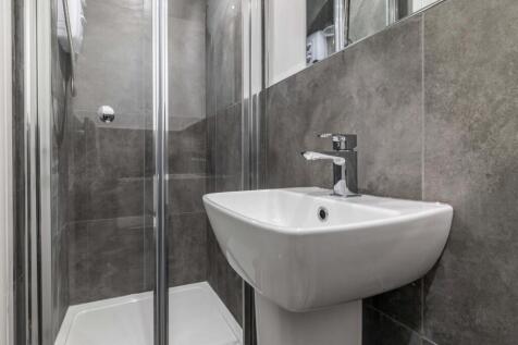 A clean and modern bathroom featuring a white s...