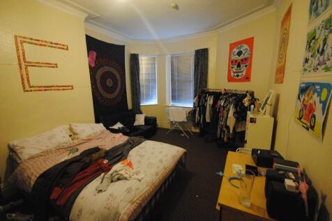 A spacious &amp; cozy master bedroom featuring a la...