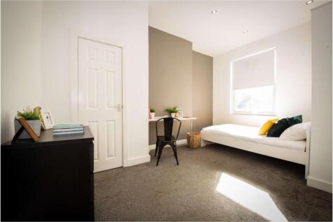 Bright and spacious master bedroom featuring a ...