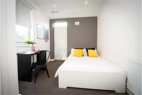 A bright and modern master bedroom featuring a ...