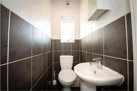 A clean and modern bathroom with a toilet and s...