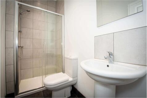 A clean and functional bathroom featuring a sho...
