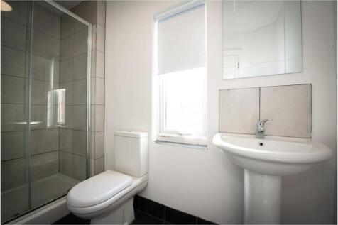 A bright and clean bathroom with a modern sink ...