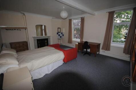 A cozy and well-maintained bedroom featuring a ...