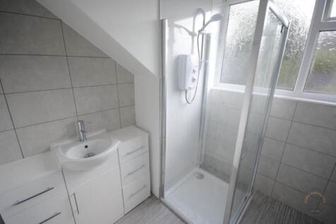 A clean and modern bathroom featuring a shower ...