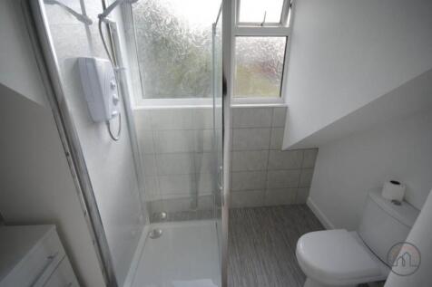 A clean, modern bathroom featuring a spacious s...